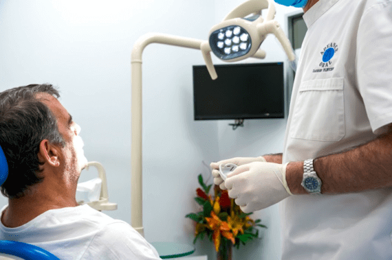 Darren Fletcher offering new dentures to a patient in his denture clinic on sunshine coast. Single denture tooth